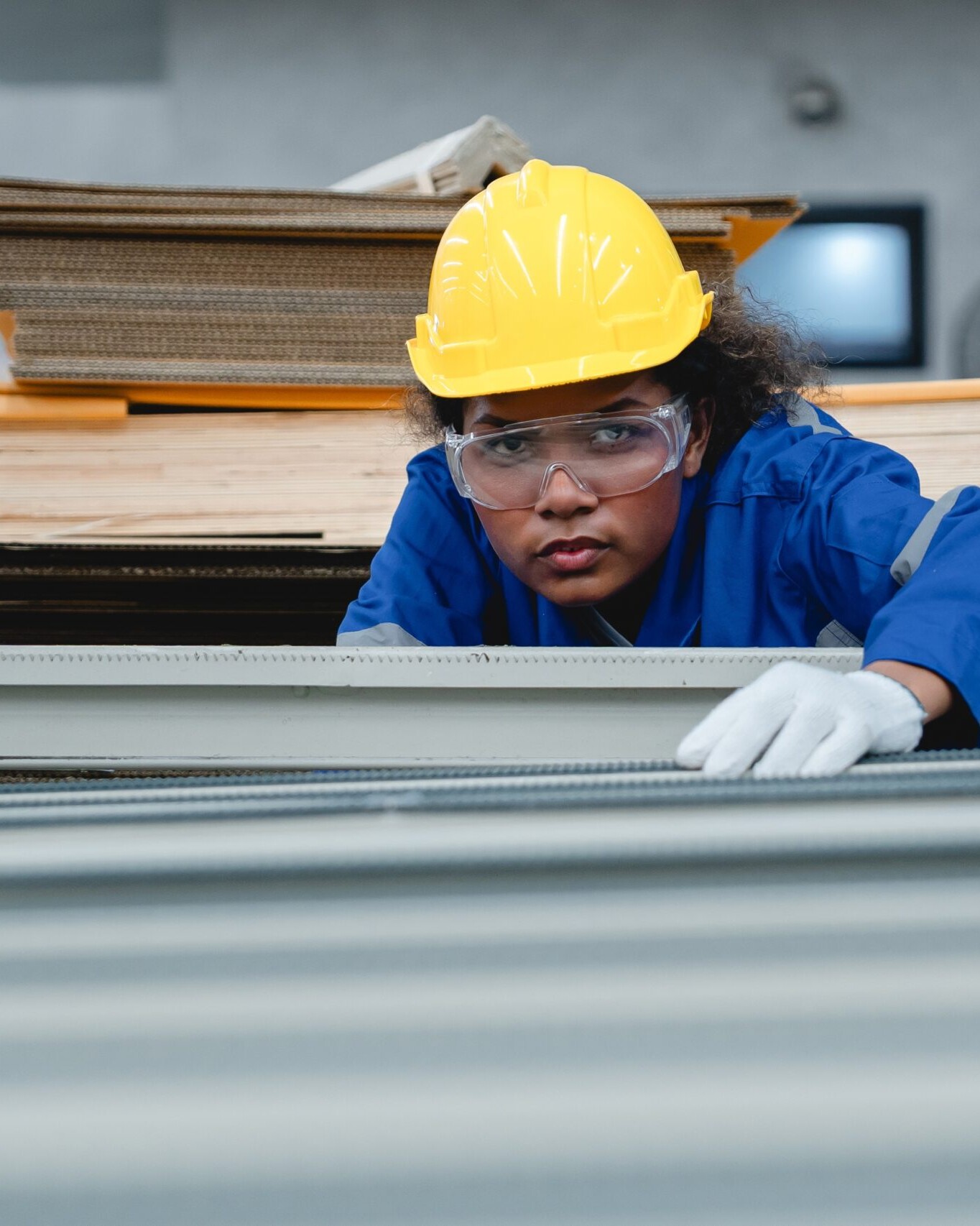 Focused,Female,Technician,Adjusting,Paper,Line,Machinery,In,Cardboard,Factory,